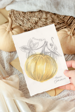 Load image into Gallery viewer, A hand holding a small artwork featuring a painted yellow pumpkin with gray botanical details, styled with real pumpkins, fabric, and paper in a warm autumn setting.
