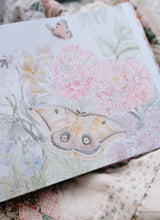 Load image into Gallery viewer, Book with butterfly and floral design on a floral fabric background